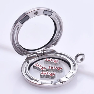 Close-up of silver magnetic floating locket with red love letter charms inside