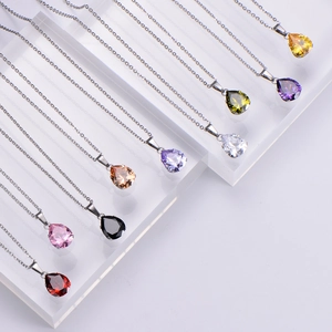 Titanium steel water drop zircon necklaces in multiple colors on acrylic display stand