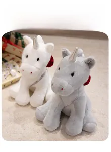 Detail of plush unicorns with silver horns, satin neck ribbons, and red back bows
