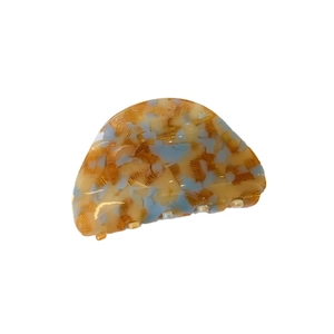 Elegant semi-round acetate hair claw clip with amber and blue tortoiseshell stripe patterns