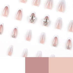 French tip press-on nails with silver glitter gradient and rhinestones in long coffin shape