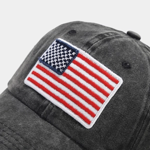 Detailed view of the American flag embroidery on a vintage washed grey baseball cap
