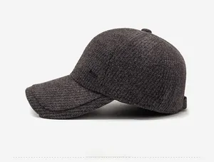 Detailed side view of dark grey ribbed knit baseball cap with ear protection and warm fleece