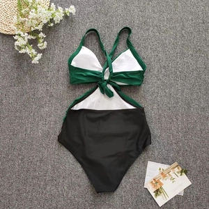 Detail of one-piece swimsuit featuring hollow waist, lace-up ties and removable padding