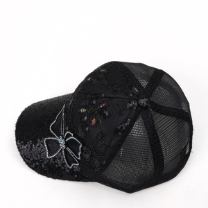 Detail of black baseball cap featuring sequins, rhinestone butterfly and breathable mesh