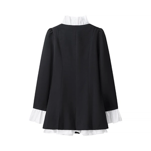 Detailed view of the Victorian style high neck collar and white ruffled hem on black dress