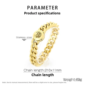 Detail of 11mm gold stainless steel Cuban link bracelet with skull emblem and 69g weight