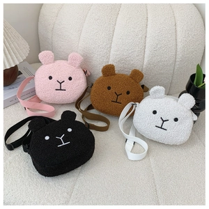 Close-up of four cute plush bear shoulder bags in pink, brown, white and black colors