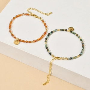 Irregular natural stone bead bracelet with stainless steel accents and round charms
