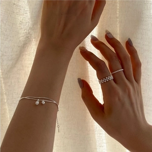 Detail of silver S925 double-layer snake chain bracelet with white pearl charms