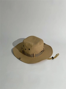 Detail of khaki outdoor boonie hat with metal eyelets and adjustable chin strap cord