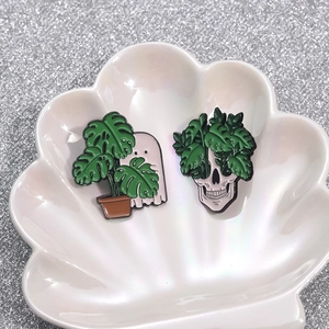 Gothic punk enamel pin set featuring ghost and skeleton with monstera leaves on shell tray