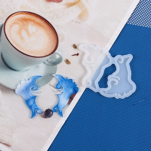 Detail of heart puzzle silicone mold with blue resin earrings on a lifestyle background