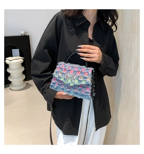 Détail du sac bandoulière en tweed à carreaux avec nœud argenté et bords effilochés