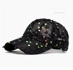 Close-up of black mesh baseball cap featuring 3D floral patches and shimmering sequins