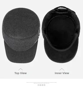 Detail of wool flat top hat featuring warm plush lining and metallic side logo