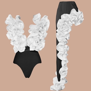 Detail view of ruffled V-neck black and white contrast one-piece swimwear skirt