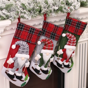 Three Christmas stockings with 3D gnomes on skis hanging from a white festive fireplace