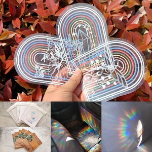 Rainbow suncatcher stickers showing floral moth patterns and holographic light effects