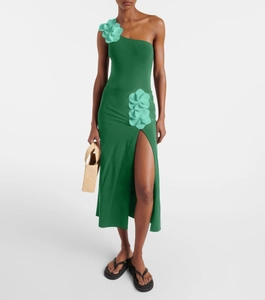 Detail of green one-shoulder swimsuit with 3D floral accents and a high slit skirt