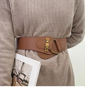 Brown wide elastic belt with vintage gold metal buckle on beige knitted sweater
