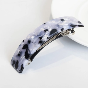 Leopard print acetate spring hair clip with purple floral patterns and metal fastener