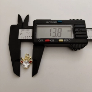 Detailed dimension measurement of golden elk pendant with zircon and red enamel