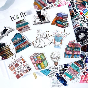 Detailed macro view of laser holographic book stickers with literary quotes on laptop