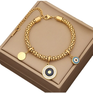 Gold stainless steel evil eye necklace with crystals and beads on a jewelry gift box