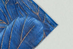 Detail of blue mesh fabric with brown branch patterns and refined printed textures