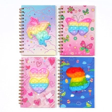 Detail of four colorful pop-it fidget notebooks in unicorn butterfly heart and dinosaur shapes