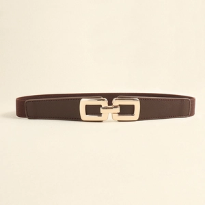 Detail of dark brown elastic belt with golden double interlocking rectangular buckle