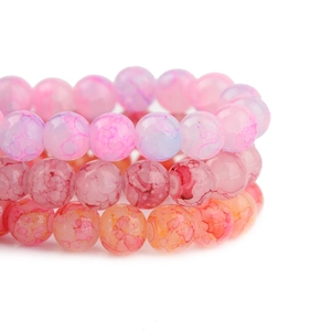 Close-up of three handmade stretch beaded bracelets with colorful crackle texture beads