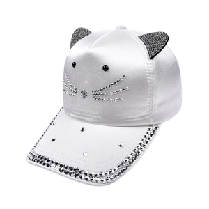 Close-up of white satin baseball cap featuring rhinestone cat ears and crystal face detailing