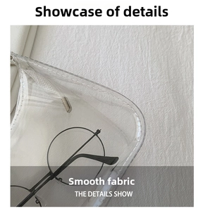 Detail of transparent PVC bag with precise stitching and a pair of round glasses inside