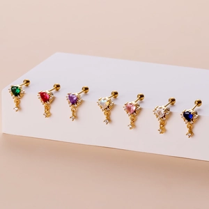 Set of seven gold heart stud earrings with colorful cubic zirconia on white display