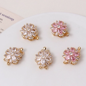 Macro detail of gold-plated peach blossom connectors with pink and white cubic zirconia