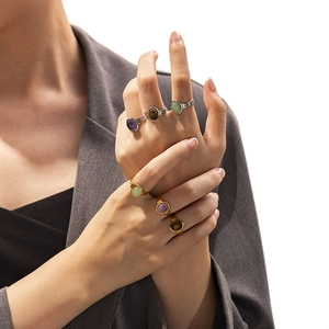 Detail shot of vintage bohemian titanium rings with colorful natural stones on hand