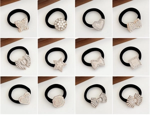 Grid display of 12 black elastic hair ties featuring pearl and rhinestone charms