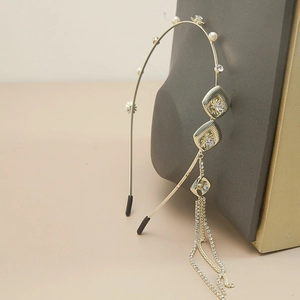 Detailed view of golden headband with diamond butterfly tassels and delicate pearl flowers