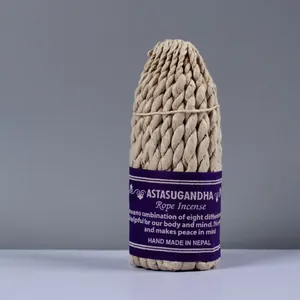 Traditional handmade Nepal rope incense bundle with purple label on grey background
