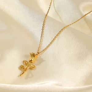 Elegant 18K gold plated 3D rose pendant necklace displayed on champagne silk fabric