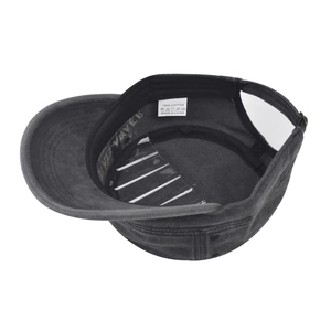 Detailed view of 100% cotton charcoal military cap interior with wash label and stitching