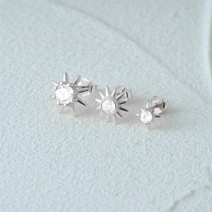 Detail showing three sizes of S925 sterling silver starburst stud earrings with zircons