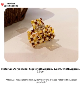 Macro shot of acetate hair claw clip showing 3.3cm x 2.3cm size and checkered pattern