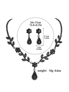Detail view of black floral rhinestone necklace and earrings with size measurements