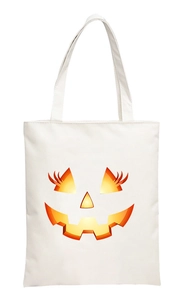 Close-up of a white canvas tote bag featuring a 2D digital printed orange pumpkin face