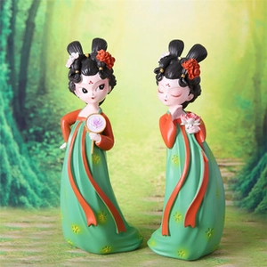Detail of two Tang dynasty style lady figurines with fans and lotus in a forest setting
