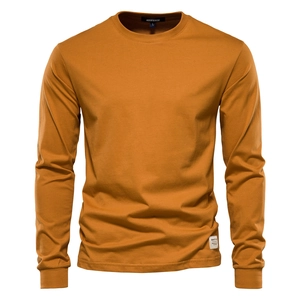 Close-up of caramel cotton fabric texture and stitching on men's long sleeve T-shirt
