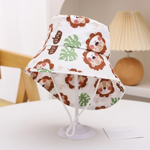 Detailed view of kids sun hat with lion print, palm leaves, and adjustable chin strap